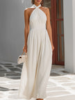 White FJØRNA twist halter neck flowy maxi dress with smocked waist, perfect for summer or casual occasions.