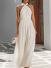 White FJØRNA twist halter neck flowy maxi dress with smocked waist, perfect for summer or casual occasions.