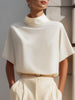 White FJØRNA women's high neck sleeveless blouse with draped minimalist design, showcasing a clean, elegant top for women.