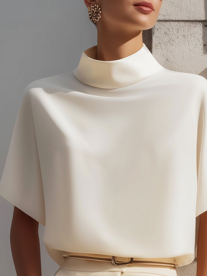 FJØRNA white high-neck sleeveless blouse for women with draped, minimalist design, ideal for elegant, modern looks.