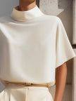 White FJØRNA women's high neck sleeveless blouse with draped, minimalist design, showcasing a stylish and elegant top for women.