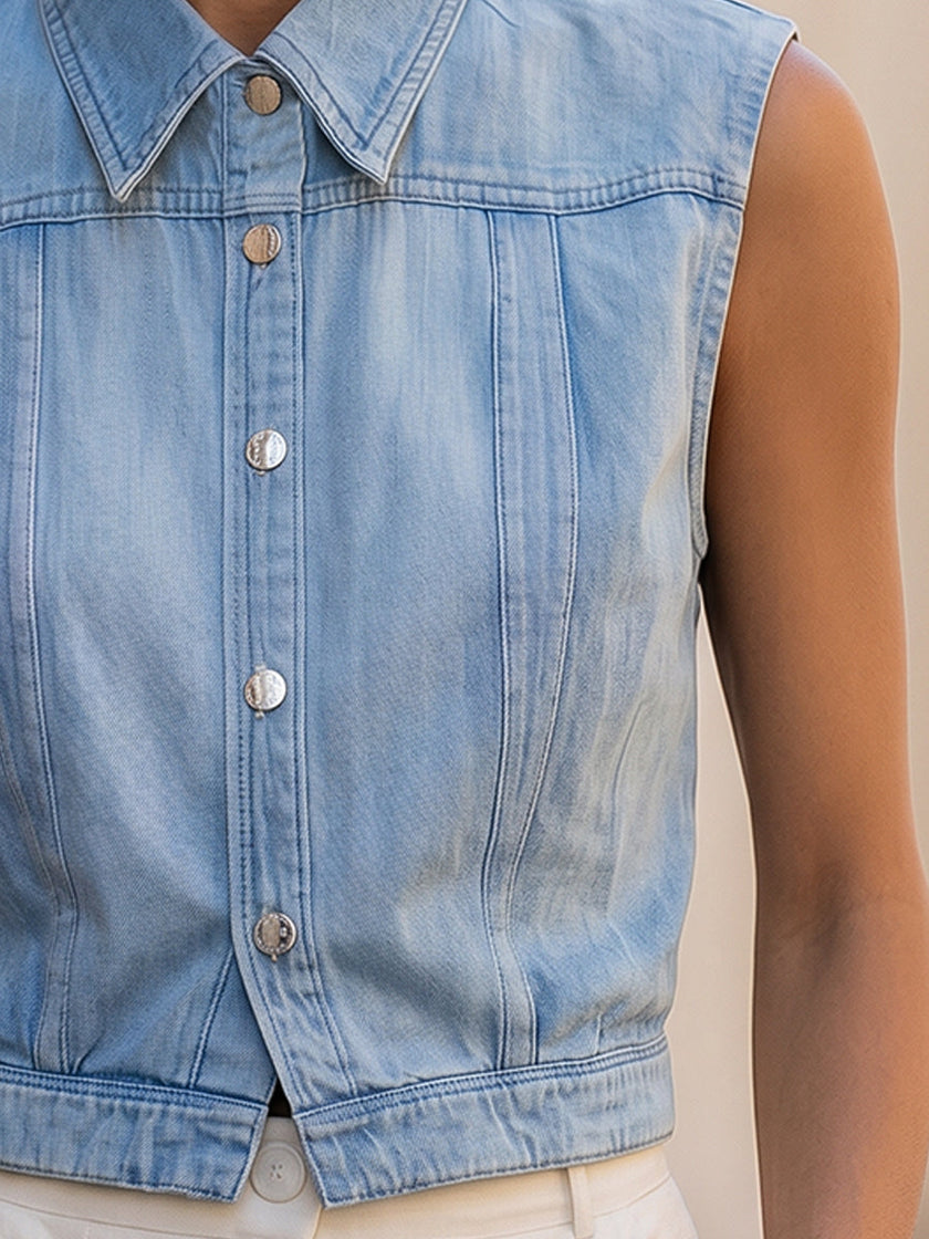 Light wash sleeveless denim vest for women with button-down front, stylish FJØRNA top, perfect for casual outfits.