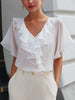 FJØRNA women’s white V-neck blouse with sheer sleeves and ruffle details, stylish top perfect for casual or dressy occasions
