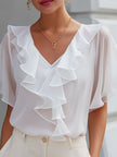 White women's blouse by FJØRNA with V-neck, sheer sleeves, and ruffle details, perfect for elegant casual or formal wear.