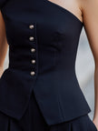 FJØRNA women’s asymmetric one-shoulder buttoned peplum structured top, stylish and fitted with a modern design.