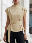 FJØRNA beige sleeveless women's top with high neck, tie waist, and gold belt buckle, showcasing a stylish and elegant design.