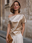 FJØRNA women's champagne one-shoulder blouse with textured, relaxed fit and asymmetric design, showcasing stylish women's tops.