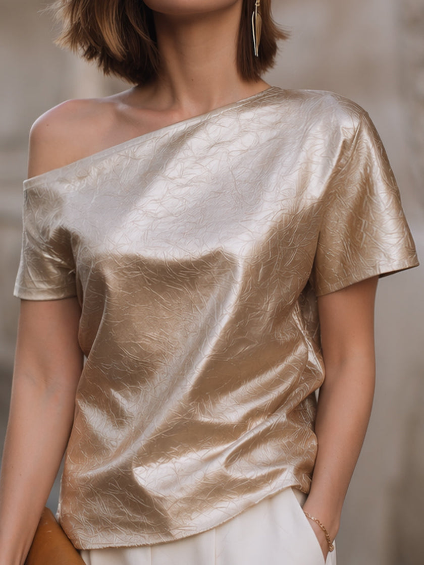 FJØRNA women's champagne-colored one-shoulder blouse with textured, relaxed fit and asymmetric design, showcasing stylish top.