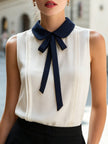 Ivory sleeveless women's blouse with Peter Pan collar and bow tie, by FJØRNA, showcasing elegant top with feminine details.