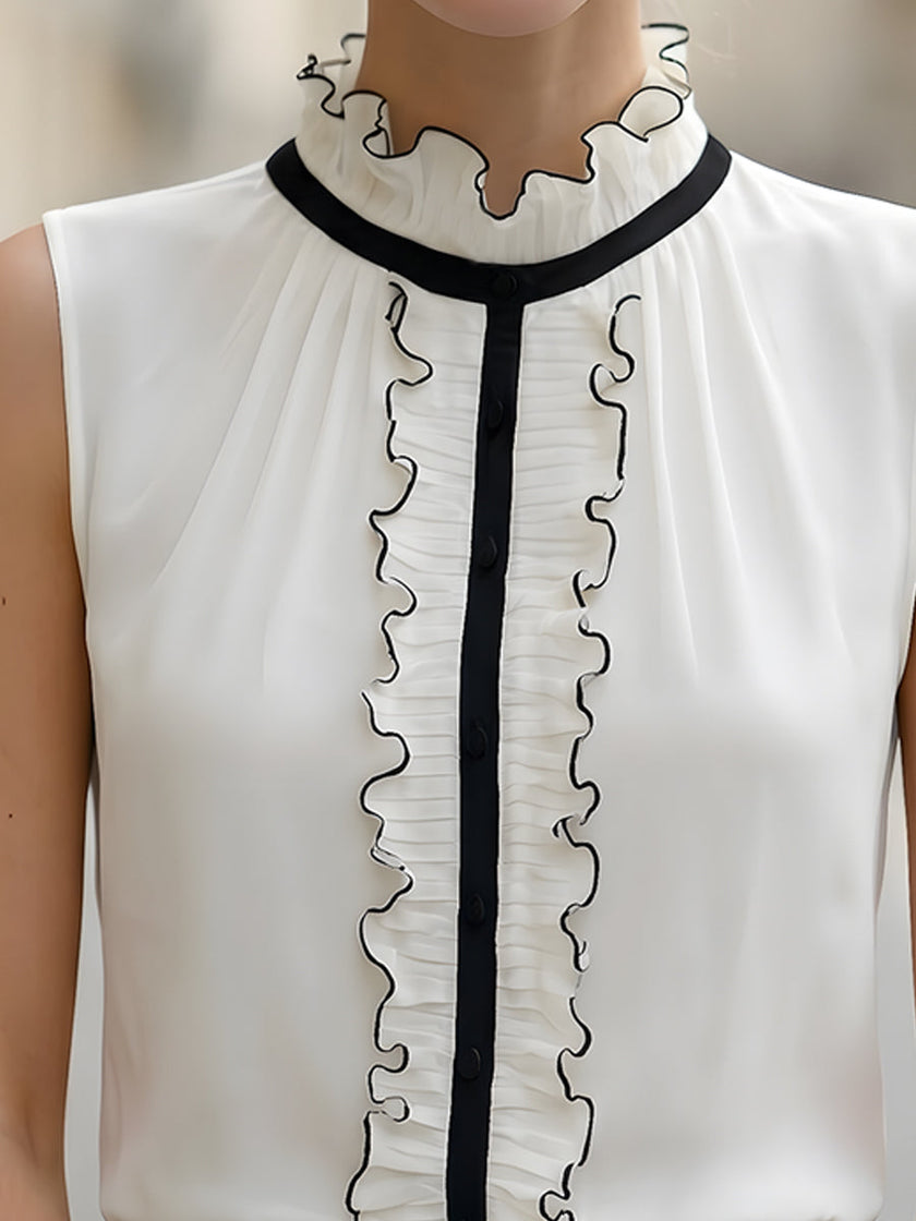 Ivory chiffon sleeveless blouse for women with ruffle high neck and black contrast trim, stylish FJØRNA top.