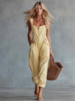 Light yellow FJØRNA denim jumpsuit with square neckline and zip-front closure, shown on a model.