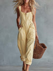 Light yellow denim jumpsuit with square neckline and front zipper from FJØRNA, shown on a model.