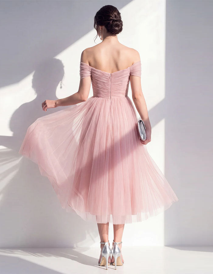 Pink tulle midi dress for women by FJØRNA, featuring a flowy silhouette and elegant design perfect for special occasions.