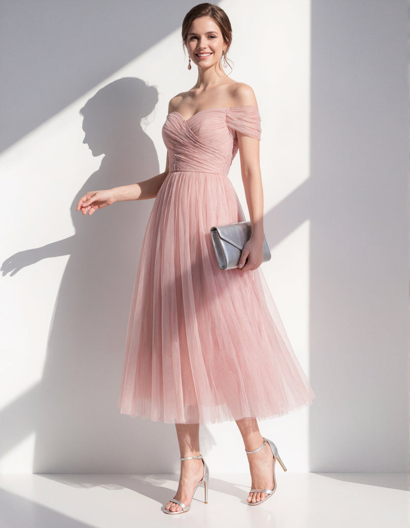 Pink tulle midi dress for women by FJØRNA, featuring a flowy design with delicate tulle fabric and elegant silhouette.