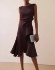 Pink FJØRNA midi dress for women with a round neck, sleeveless design, ruffle details, and bow accents.