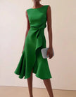 Pink FJØRNA women's midi dress with round neck, sleeveless design, ruffle and bow details, perfect for stylish summer wear.