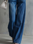 Blue washed denim sleeveless jumpsuit with collar for women, from FJØRNA, featuring a casual, stylish design.