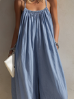 FJØRNA loose-fit sleeveless women's jumpsuit with square neck, gathered bodice, and wide-leg pants, shown in the image.