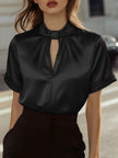FJØRNA satin women's blouse with high neck, keyhole detail, and short sleeves, featuring a smooth, shiny fabric.