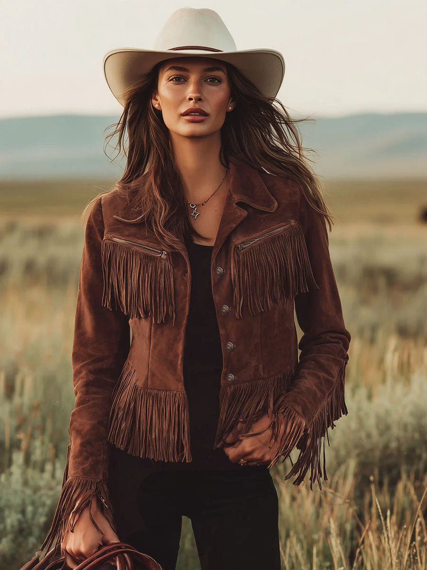 Brown suede Western tassel zip-up jacket by FJØRNA featuring fringe tassels and a fitted design, styled on a model.
