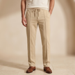 FJØRNA men's straight leg trousers with drawstring waistband, relaxed fit, lightweight fabric, and classic style.