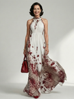 FJØRNA women's floral summer maxi dress with long sleeves and pleated design, flowing and elegant for warm weather.
