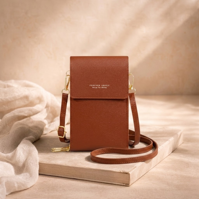 FJØRNA women's crossbody bag with adjustable strap, black leather design, featuring sleek and minimalist style.