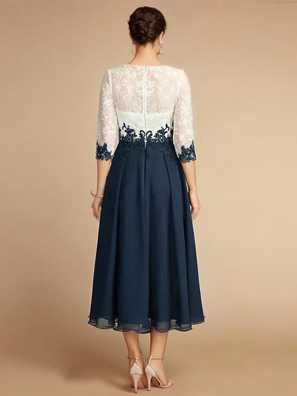 White chiffon midi dress for women with a round neck by FJØRNA, shown hanging on a clothing rack.