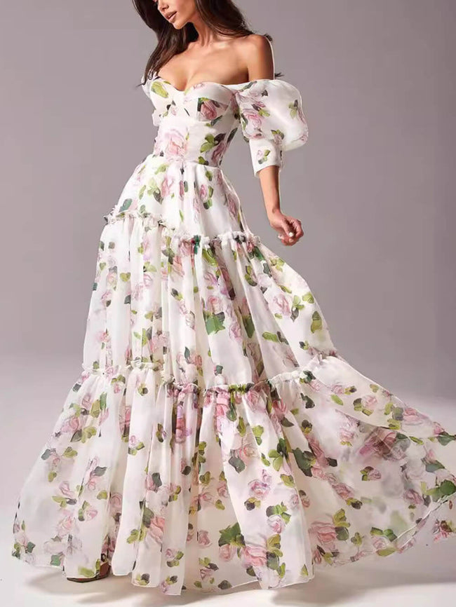 Elegant off-shoulder printed organza evening gown by FJØRNA, featuring a flowing maxi dress with floral patterns and a sophisticated design.