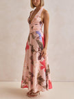 FJØRNA floral print halter backless tie-up women's maxi dress hanging on a display mannequin.