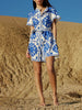 FJØRNA Mediterranean style printed tie mini dress for women, featuring vibrant patterns and a flattering fit.