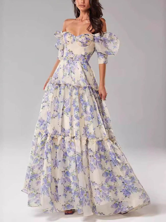 Elegant off-shoulder printed organza evening gown by FJØRNA featuring a flowing maxi dress with floral patterns and a stylish neckline.