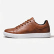 FJØRNA men's leather lace-up low top sneakers in black with white soles, showing detailed leather texture and casual style.