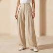 Women’s high waisted wide leg tailored trousers by FJØRNA, featuring a sleek fit and classic design, displayed on a white background.
