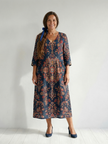 FJØRNA women's summer midi dress with long sleeves, wrap style, flowy design, and premium fabric, perfect for warm weather.