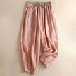 FJØRNA women’s linen tapered trousers with a relaxed fit, featuring a high waist and side pockets, displayed on a hanger.