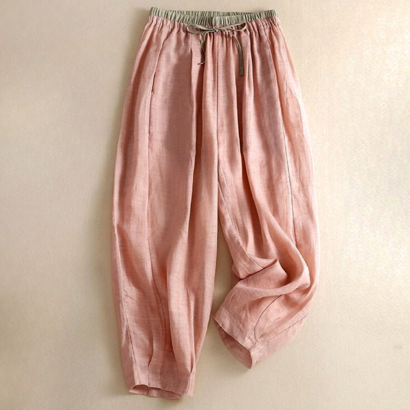 FJØRNA women’s linen tapered trousers with a relaxed fit, featuring a high waist and side pockets, displayed on a hanger.
