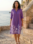 FJØRNA elegant women's dress with floral pattern and pockets, showcasing a flowy design and stylish details.