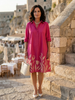 FJØRNA women's summer dress with floral pattern and pockets, lightweight and casual for warm weather, showcased on a hanger.