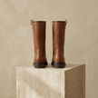 FJØRNA women's leather boots featuring ankle-high design and sleek black leather, stylish footwear for women.