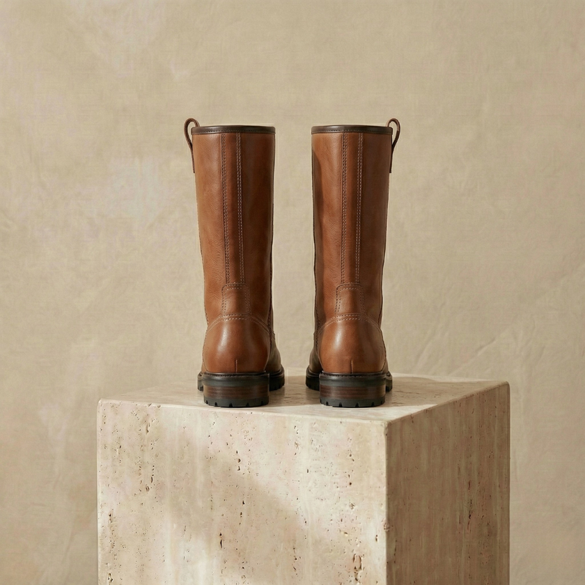 FJØRNA women's leather boots featuring ankle-high design and sleek black leather, stylish footwear for women.