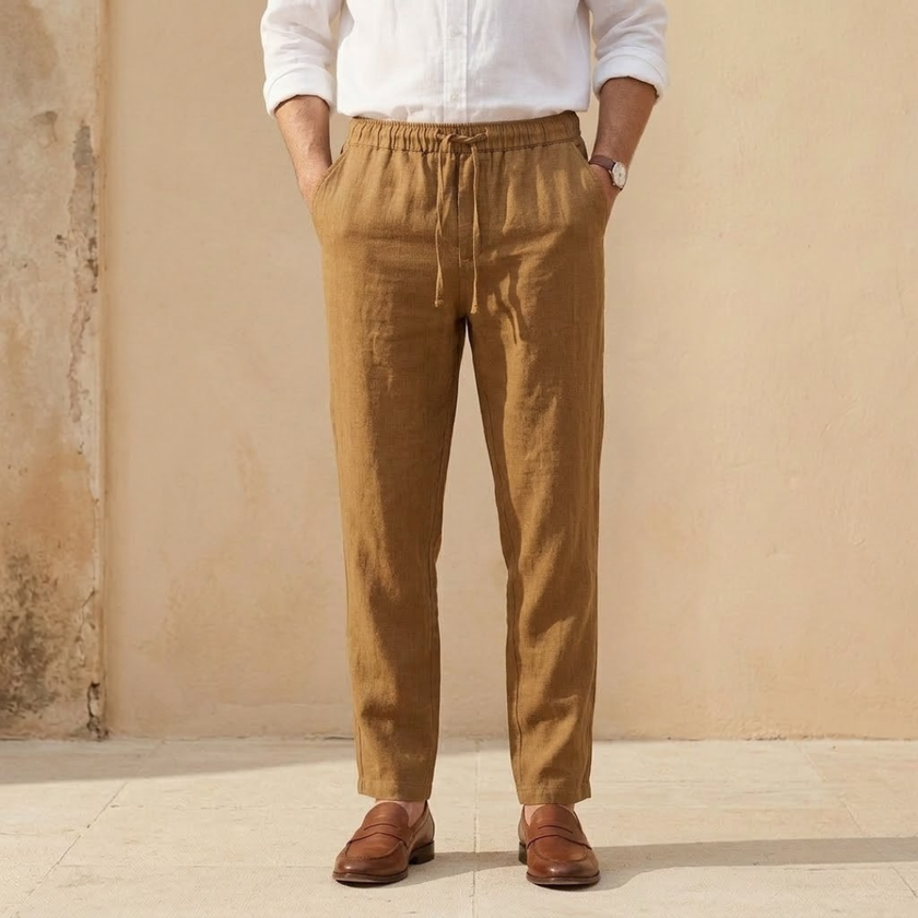 Men's linen blend straight leg trousers by FJØRNA with drawstring waist and relaxed fit, shown on a model.