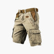 Men's FJØRNA cargo shorts with multiple functional pockets and ample storage, shown in a casual outdoor setting.