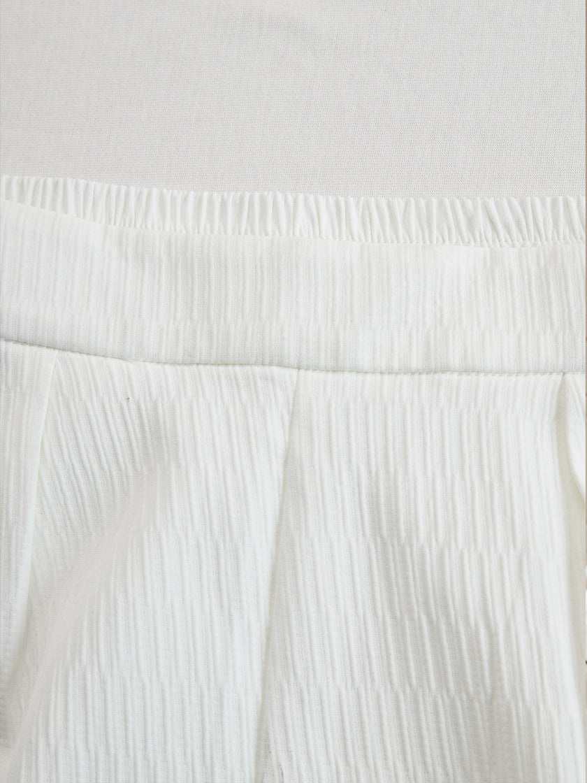 Cream textured lantern sleeve two-piece pants set by FJØRNA, featuring lantern sleeves and matching coordinated pants.