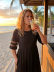 FJØRNA elegant midi wrap dress for women, stylish evening dress with a sophisticated silhouette, displayed on a model.
