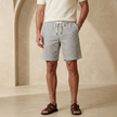 FJØRNA men's relaxed fit drawstring shorts in lightweight fabric, featuring side pockets and casual style.