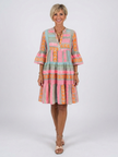 FJØRNA women's geometric tiered summer dress with sleeveless design and vibrant pattern, perfect for warm-weather wear.