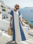 FJØRNA women's summer maxi dress with short sleeves, flowy fabric, and vibrant floral pattern for a breezy, stylish look.