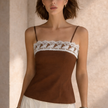 Women’s cotton camisole top with lace trim from FJØRNA, perfect for summer, featuring a sleeveless design and lightweight fabric.