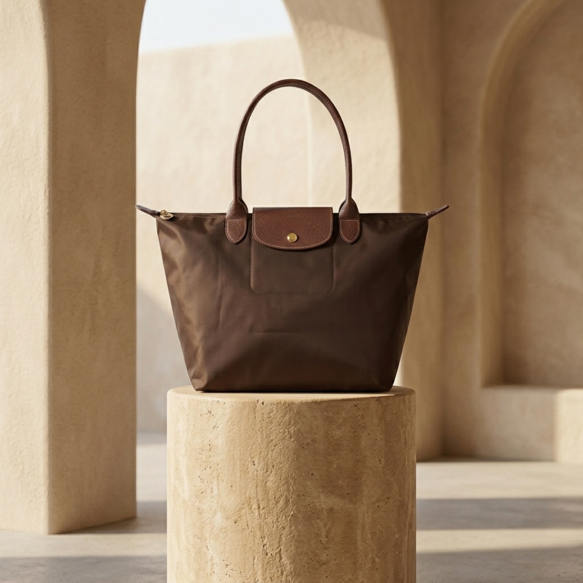 FJØRNA leather tote bag for women, large foldable bag with spacious interior and stylish design, shown in brown leather.